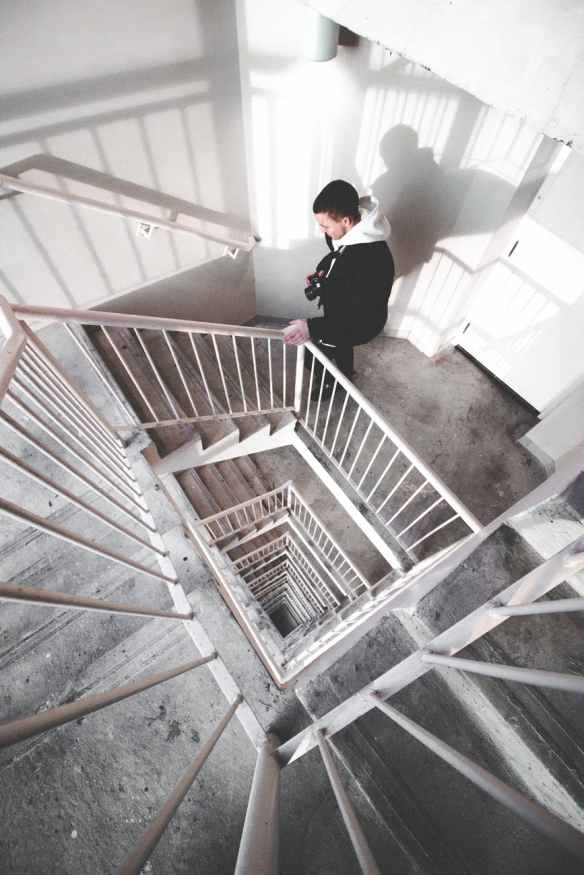 man walking on spiral stairs