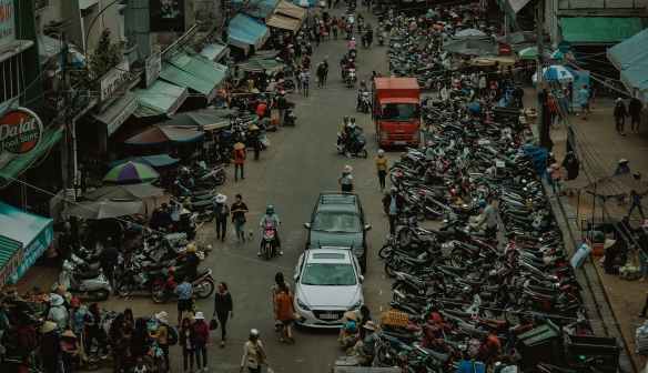 group of people walking through market